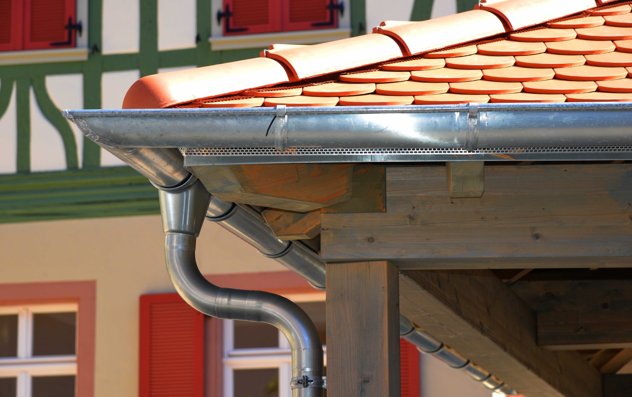Image of a strong and durable Steel Gutter system, installed on a commercial building's roof. The Steel material is resistant to impact, weathering, and fire, making it ideal for high-traffic and high-risk areas.